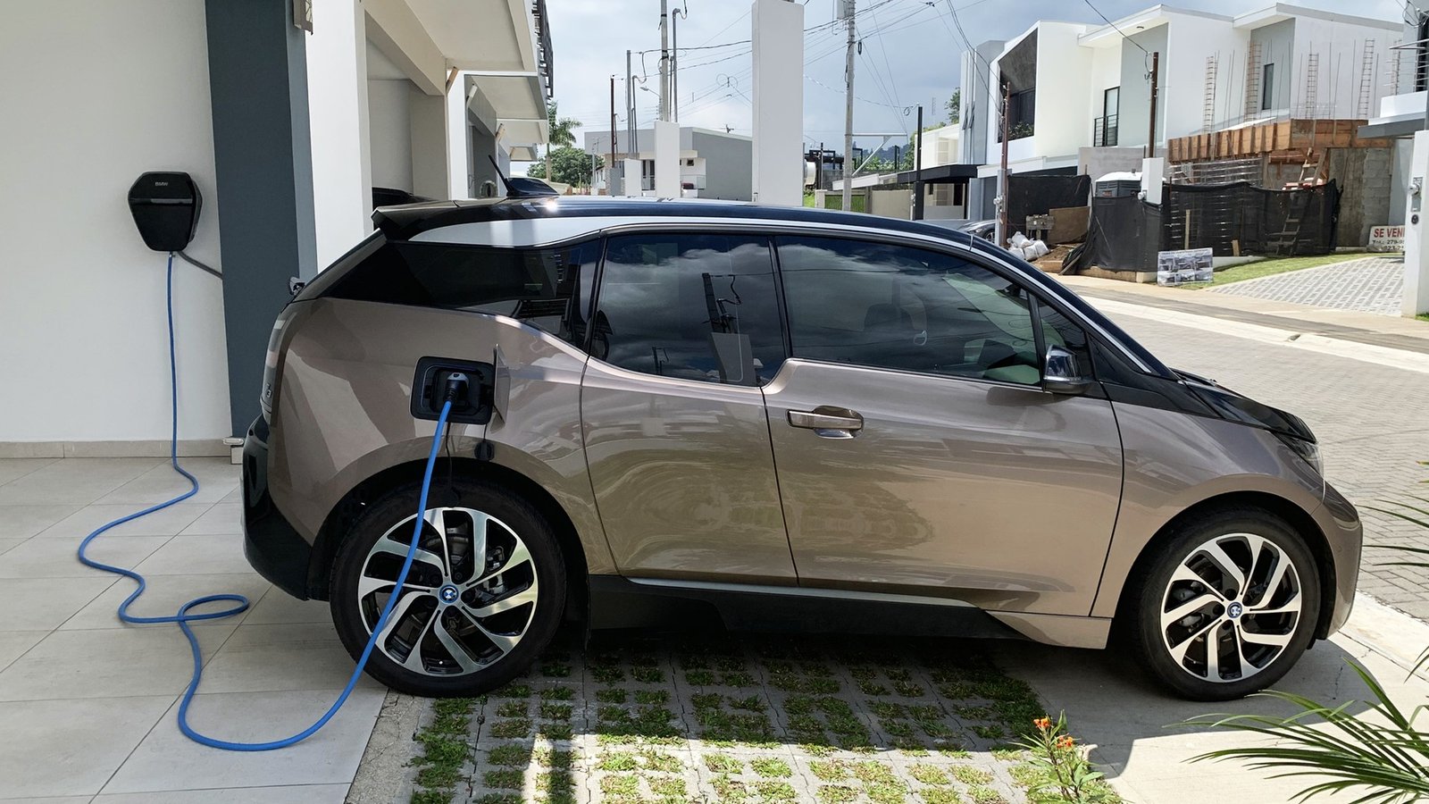 Electric car plugged into a home wallbox charger