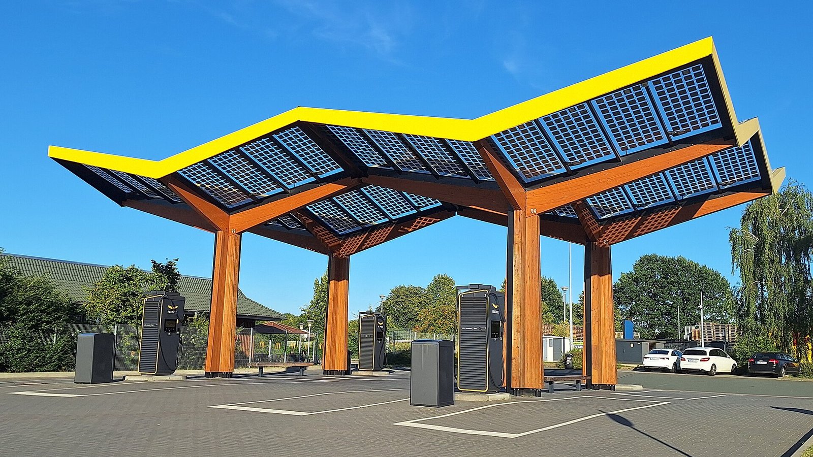 High-power Fastned chargers under a solar canopy at a motorway service area