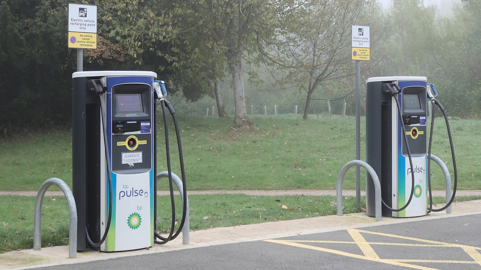 Row of BP Pulse rapid EV chargers at a public charging hub