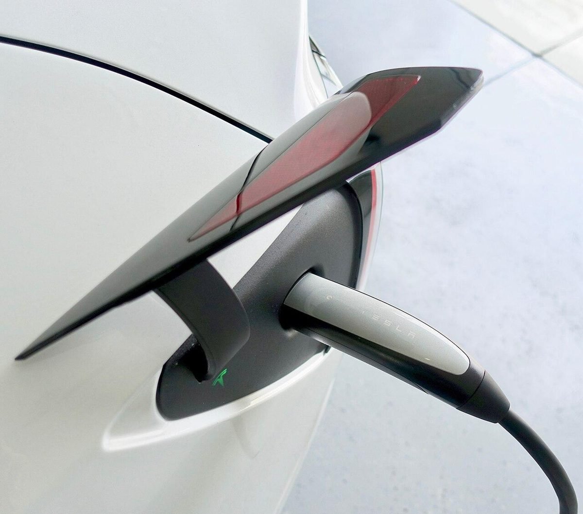 Tesla Model 3 plugged in to a Tesla Mobile Connector portable charging cable